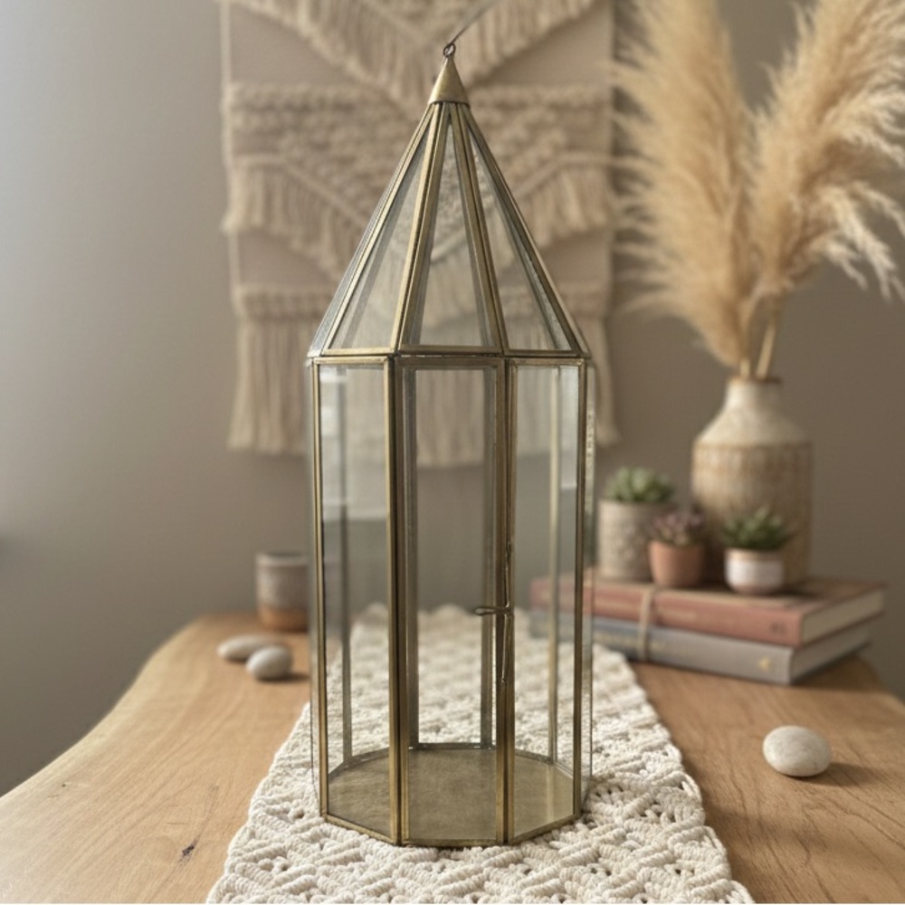 geometric glass lantern or terrarium with a vintage, "Wardian case" aesthetic.